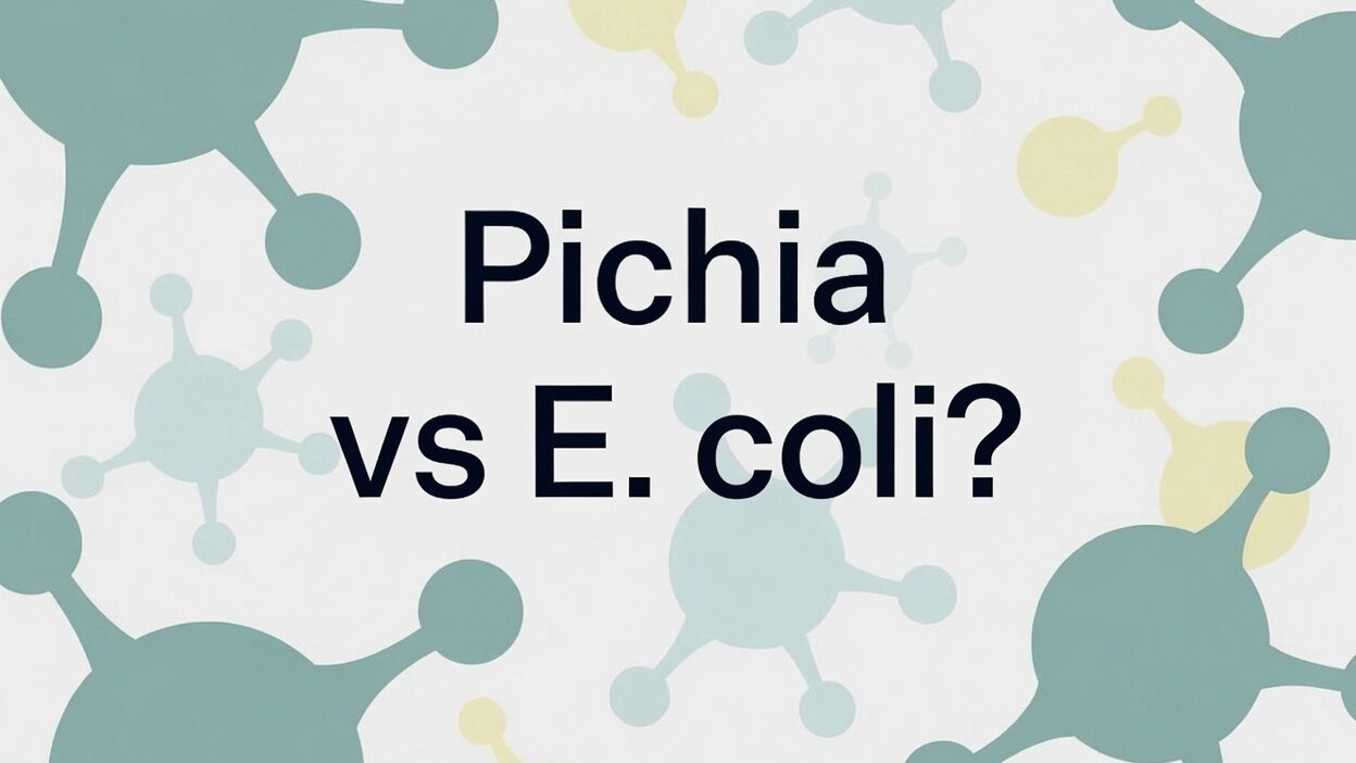 Banner graphic with the bold centered text “Pichia vs E. coli?” on a soft white background. Abstract molecular structures in muted teal-green, light blue, and pale yellow surround the text. Clean, minimal biotech illustration style.